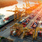 Logistics and transportation of Container Cargo ship and Cargo plane with working crane bridge in shipyard at sunrise, logistic import export and transport industry background